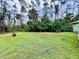 Expansive backyard features lush greenery with plenty of trees for privacy at 15090 Rebecca Ave, Port Charlotte, FL 33953