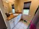 Bathroom featuring a vanity with granite countertop and window with blinds at 15090 Rebecca Ave, Port Charlotte, FL 33953