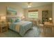 Bright bedroom features a ceiling fan, a window, and a neutral color palette at 15090 Rebecca Ave, Port Charlotte, FL 33953