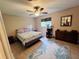 Comfortable bedroom boasts tile floors, area rug, and a window with a cat tree at 15090 Rebecca Ave, Port Charlotte, FL 33953