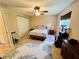 Bedroom with tile floor has a large window, closet, and neutral color scheme at 15090 Rebecca Ave, Port Charlotte, FL 33953