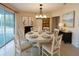 Elegant dining room showcasing a round table set for six, with a fireplace and sliding glass doors at 15090 Rebecca Ave, Port Charlotte, FL 33953