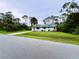 Exterior view of home with front yard landscaping and a driveway at 15090 Rebecca Ave, Port Charlotte, FL 33953