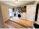 Well-lit laundry room with modern washer and dryer units, shelving, and ample space for storage at 15090 Rebecca Ave, Port Charlotte, FL 33953