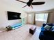 Bright living room with tile flooring, a large window, and a ceiling fan, ideal for Gathering gatherings at 15090 Rebecca Ave, Port Charlotte, FL 33953