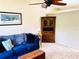 Cozy living room showcases a comfortable blue couch and wooden furnishings at 15090 Rebecca Ave, Port Charlotte, FL 33953