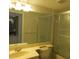 Well-lit bathroom featuring a large mirror, a toilet and a glass-door shower at 429 Cerromar Ln # 353, Venice, FL 34293