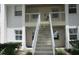 Exterior stairs leading to units above, with a well-maintained facade at 429 Cerromar Ln # 353, Venice, FL 34293
