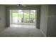 Bright living room with a sliding glass door and neutral carpeting at 429 Cerromar Ln # 353, Venice, FL 34293
