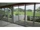 Glass doors open to the patio, overlooking lush green spaces and manicured landscaping at 429 Cerromar Ln # 353, Venice, FL 34293