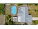 Overhead view showcases a swimming pool and home with metal roof at 732 Haleybury St, Port Charlotte, FL 33948