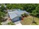 Aerial view of the home with mature landscaping, fenced yard, and long driveway at 732 Haleybury St, Port Charlotte, FL 33948