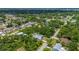 Wide aerial shot of the home, highlighting the mature landscaping and private pool area at 732 Haleybury St, Port Charlotte, FL 33948