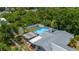 Angle aerial showing back of house with pool, patio area, and fenced yard at 732 Haleybury St, Port Charlotte, FL 33948