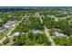 Overhead view of the home and property with lush surrounding greenery and neighborhood at 732 Haleybury St, Port Charlotte, FL 33948