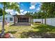 Backyard view showing a pergola, swing, and an above-ground swimming pool at 732 Haleybury St, Port Charlotte, FL 33948
