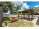 The backyard has a relaxing swing set and a pergola for outdoor enjoyment at 732 Haleybury St, Port Charlotte, FL 33948