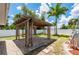 Outdoor pergola provides shade in this sunny backyard with lush tropical palm trees at 732 Haleybury St, Port Charlotte, FL 33948
