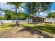 Backyard featuring a pergola, above-ground pool, and swing in a lush outdoor setting at 732 Haleybury St, Port Charlotte, FL 33948