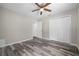 Spacious bedroom features wood-look flooring, a ceiling fan, and a closet at 732 Haleybury St, Port Charlotte, FL 33948