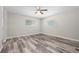 Bedroom with two windows offering natural light, gray-tone flooring, and neutral walls at 732 Haleybury St, Port Charlotte, FL 33948