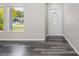 Inviting foyer featuring wood-look flooring, an oval glass front door, and natural light at 732 Haleybury St, Port Charlotte, FL 33948
