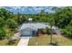 Single-story home featuring well-maintained landscaping, a metal roof and an attached garage at 732 Haleybury St, Port Charlotte, FL 33948