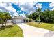 Charming home exterior with well-manicured lawn, driveway, and appealing curb appeal at 732 Haleybury St, Port Charlotte, FL 33948