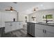 Bright kitchen with white cabinetry, stainless steel appliances, and a granite island with a sink at 732 Haleybury St, Port Charlotte, FL 33948