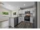 Modern kitchen features white cabinets, stainless steel appliances, and granite countertops at 732 Haleybury St, Port Charlotte, FL 33948