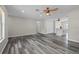 Living room seamlessly connects to the kitchen, boasting wood-look floors and recessed lighting at 732 Haleybury St, Port Charlotte, FL 33948