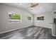 Bright living room with vaulted ceiling, ceiling fan, and windows overlooking the yard and pool at 732 Haleybury St, Port Charlotte, FL 33948