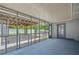 Enclosed patio offers a view of the backyard, featuring a pergola, and privacy fence at 732 Haleybury St, Port Charlotte, FL 33948