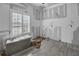 Bedroom under renovation featuring new gray tile flooring and modern window shutters at 7696 Plantation Cir, Bradenton, FL 34201