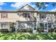 Charming home exterior with screened-in patios, red shutters, and well-maintained landscaping at 7696 Plantation Cir, Bradenton, FL 34201