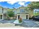 Inviting townhome featuring a one car garage, a well-maintained lawn, and colorful landscaping at 7696 Plantation Cir, Bradenton, FL 34201