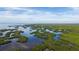 Beautiful aerial view of islands with lush mangroves near tranquil waters under a blue sky at 8178 Arlewood Cir, Port Charlotte, FL 33981