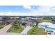 An aerial view showcasing homes with boat docks on canals, lush landscaping, and well-maintained lawns at 8178 Arlewood Cir, Port Charlotte, FL 33981