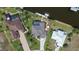 Aerial view showing the home's landscaping, pool, and dock at 8178 Arlewood Cir, Port Charlotte, FL 33981