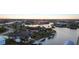 Expansive waterfront property with private dock and boat lift at sunset at 8178 Arlewood Cir, Port Charlotte, FL 33981