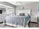 Bright bedroom featuring a large bed with a blue comforter and decorative pillows, plus white furnishings at 8178 Arlewood Cir, Port Charlotte, FL 33981