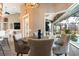 This dining area features a round table, four chairs, and a view of the pool outside of a large glass window at 8178 Arlewood Cir, Port Charlotte, FL 33981