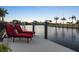 Inviting waterfront outdoor seating with beautiful sunset views at 8178 Arlewood Cir, Port Charlotte, FL 33981