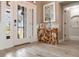 Inviting entryway features wood-look tile flooring, a driftwood console table, and elegant decor at 8178 Arlewood Cir, Port Charlotte, FL 33981