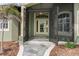 Charming front entrance featuring double doors and decorative stonework around the walkway at 8178 Arlewood Cir, Port Charlotte, FL 33981