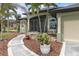 Welcoming entrance with double doors, elegant stonework, and lush landscaping at 8178 Arlewood Cir, Port Charlotte, FL 33981