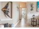 Inviting hallway with stylish decor, neutral tones, and wood-look tile flooring throughout the home at 8178 Arlewood Cir, Port Charlotte, FL 33981