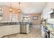 Bright kitchen featuring granite countertops, stainless steel appliances, and an adjacent dining area with pool views at 8178 Arlewood Cir, Port Charlotte, FL 33981