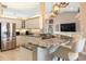 Well-appointed kitchen with granite counters, a stainless steel fridge, and stylish pendant lighting at 8178 Arlewood Cir, Port Charlotte, FL 33981