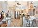 Modern kitchen with white cabinetry, stainless steel appliances, granite countertops, and breakfast bar seating at 8178 Arlewood Cir, Port Charlotte, FL 33981
